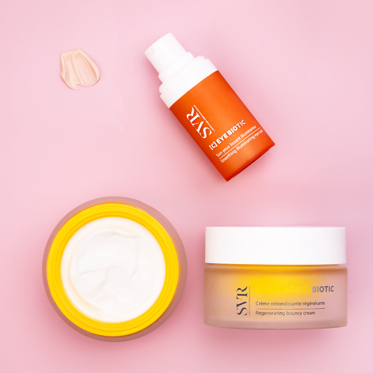 SVR C-Eye Biotic pump bottle and Collagen Biotic cream jar with white lids on a soft pink background.