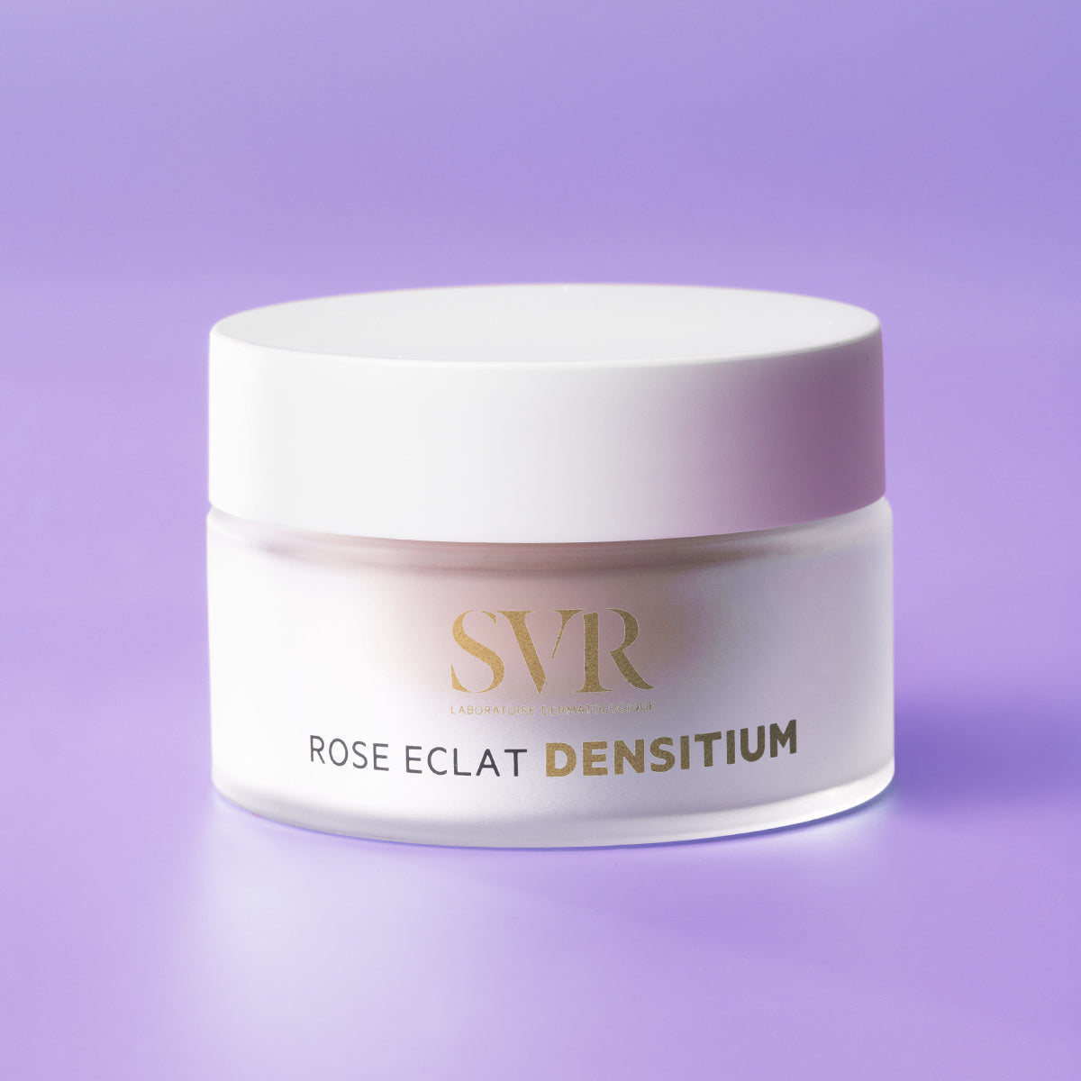 SVR Densitium Rose Éclat cream in a frosted glass jar with a white lid against a soft purple background.
