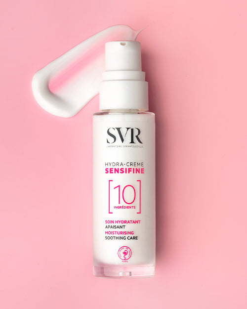 SVR Sensifine Hydra-Crème pump bottle with a white cream swatch on a soft pink background.