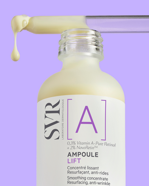 SVR Ampoule Lift serum bottle with a glass dropper dispensing creamy yellow retinol concentrate against a purple background.