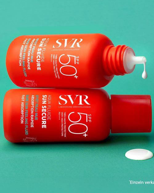 Two bright orange SVR SUN SECURE SPF50+ sunscreen bottles stacked on a teal background with a drop of white fluid.