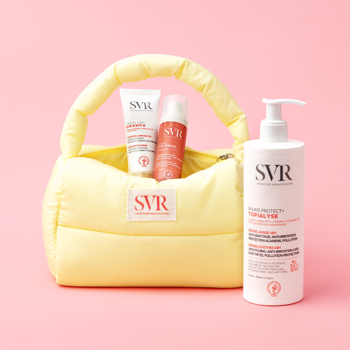 SVR Hautpflege-Set mit Cicavit+ Creme, Palpebral Balsam und Topialyse Lotion in einer gelben, gepolsterten Kosmetiktasche.